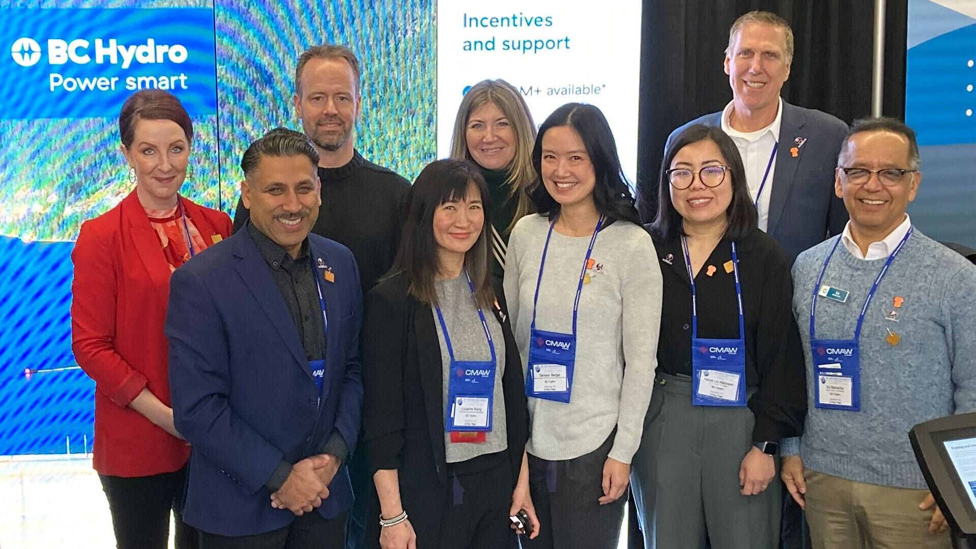 A group of people standing in front of a BC Hydro Power Smart Display