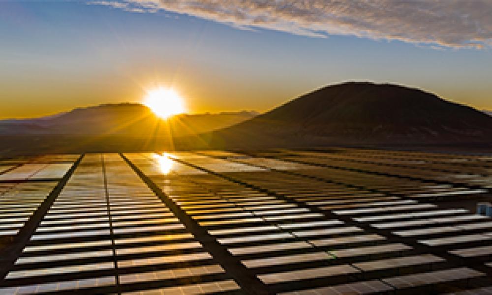 Solar panels with a sunset in the background