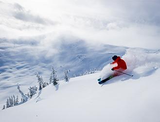 A man skiing down a snowy slope at Whistler Mountain